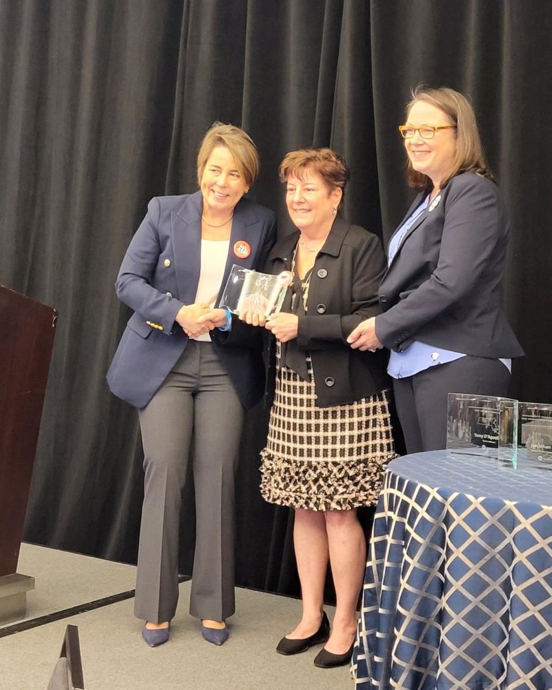 Gov. Maura Healey presents Patti Lloyd with the Larry D. Meehan Lifetime Achievement award at the Governor's Conference on Travel and Tourism on April 2. 