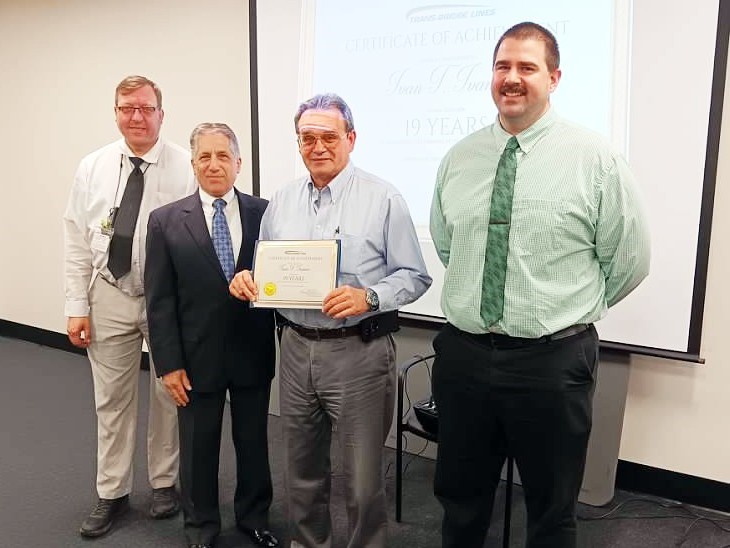 Motorcoach Driver Ivan Ivanov is presented with a certificate of achievement and company pin for 17 years of safe driving. Pictured left to right are: Brendan Stanczyk, Training Manager; Tom JeBran, President; Ivan Ivanov, Driver; and Shane Gray, Transportation Manager.